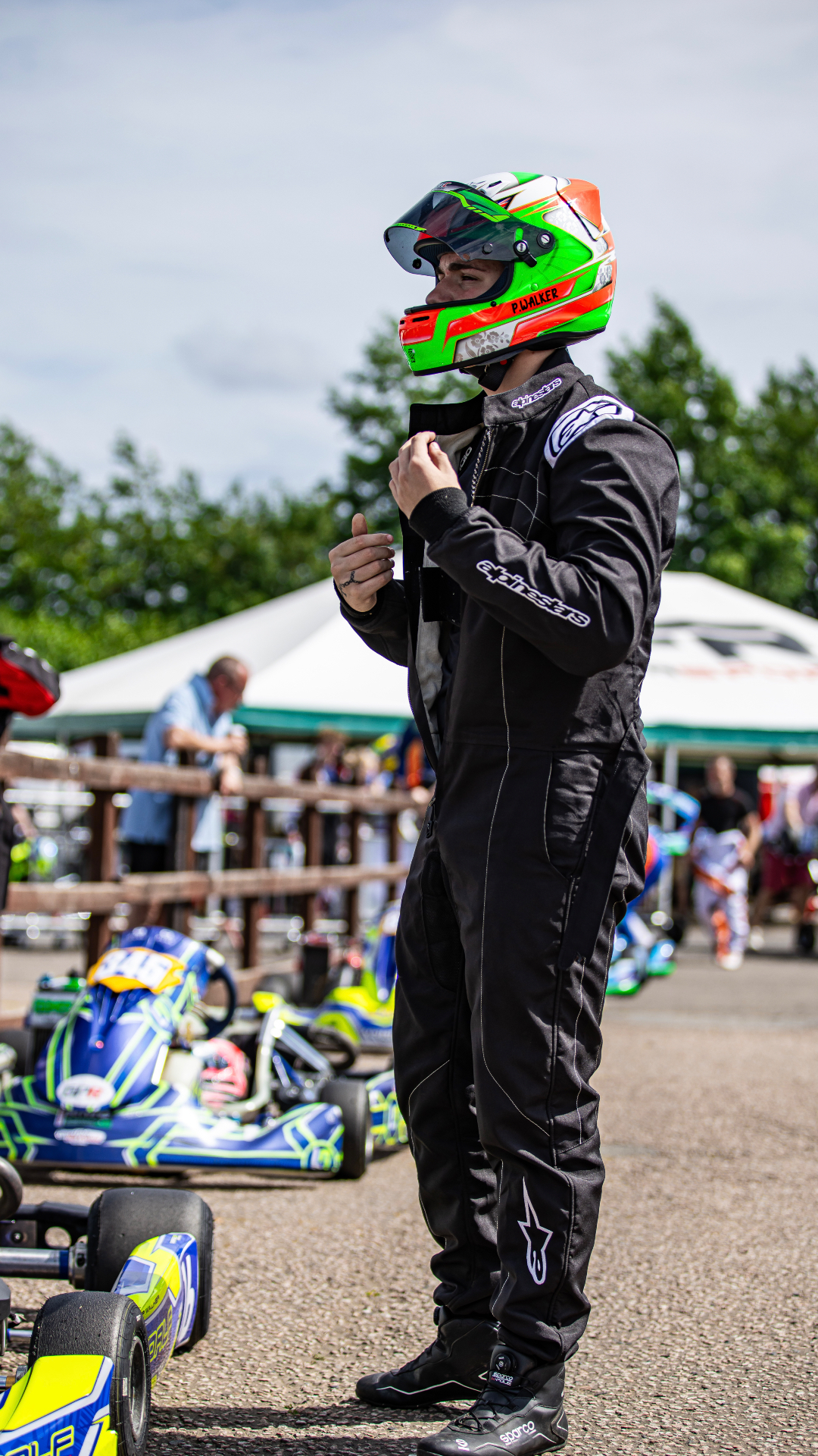 Presley Walker zipping up his race suit in the paddock